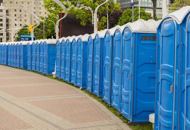 a line of portable restrooms at an outdoor wedding, catering to guests with style and comfort in Astatula